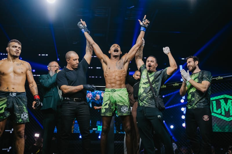 Vitória anunciada no cage da Liga Monstro Combate, com equipe técnica ao redor do atleta